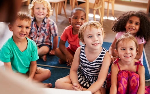 a group of children sitting on the ground
