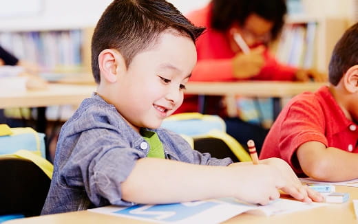 a young boy sitting at a desk