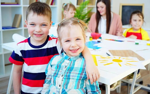 a couple of children smiling