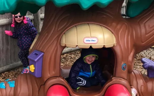 a couple of kids in a play structure