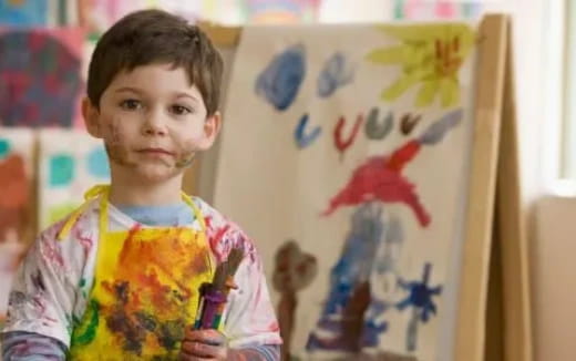 a child holding a marker pen