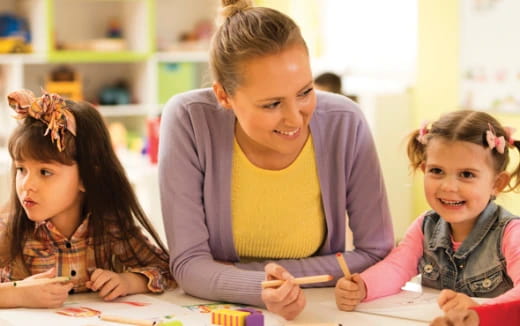 a person and children sitting at a table