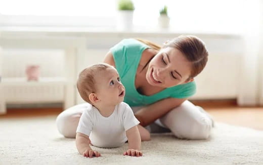 a person and a baby lying on the floor