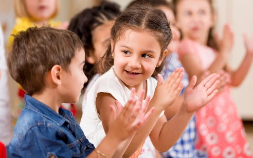 a group of children clapping