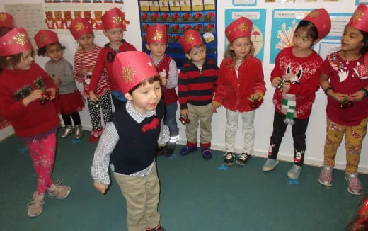 a group of children wearing red and white hats