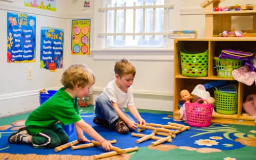 children playing with sticks in a classroom