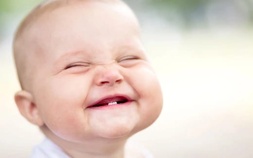 a baby crying with its eyes closed