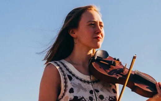 a woman playing a violin