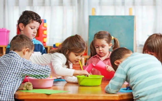 a group of children sitting at a table