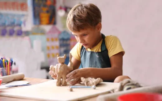 a young boy sitting at a desk