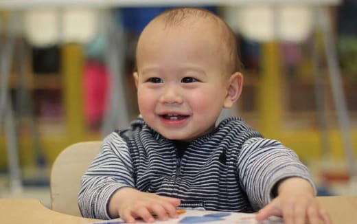 a baby sitting at a table