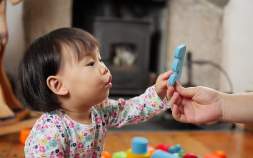 a baby brushing her teeth