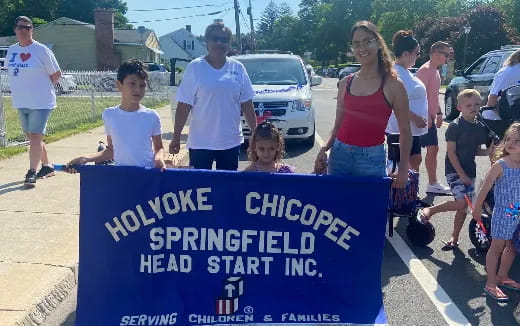 a group of people holding a sign
