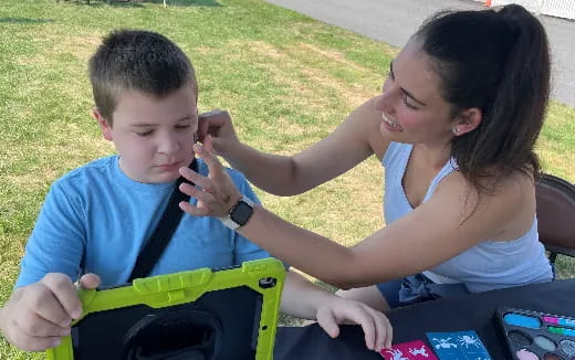 a person and a boy playing with a toy car