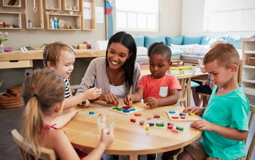 a person and several children playing a board game