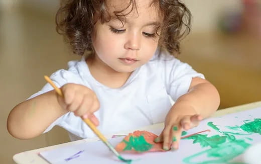 a young girl coloring on a paper