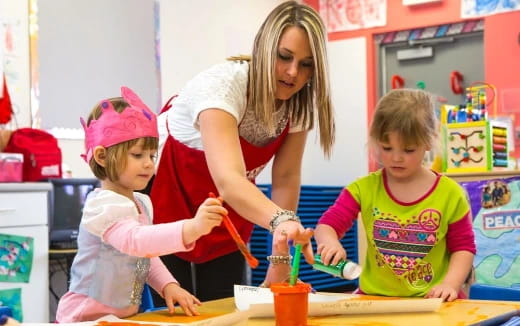 a person and children in a classroom