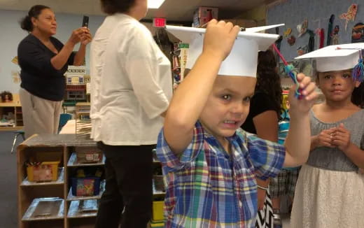 a young girl holding a toy