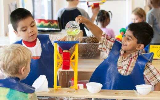 a group of children sitting at a table