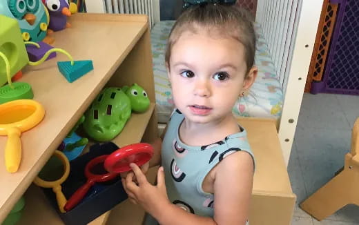 a baby holding a toy