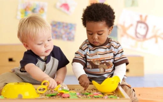 two boys playing with toys