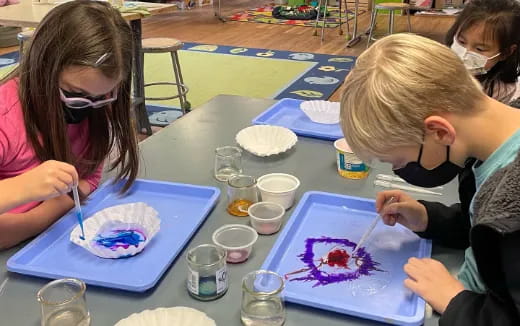 a group of children painting