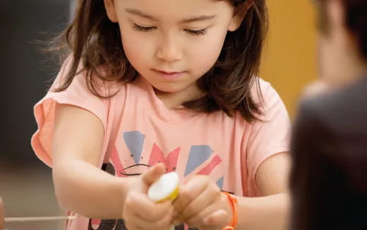 a girl holding a toy