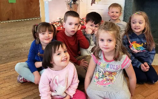 a group of children sitting on the floor