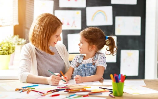 a woman and a child painting