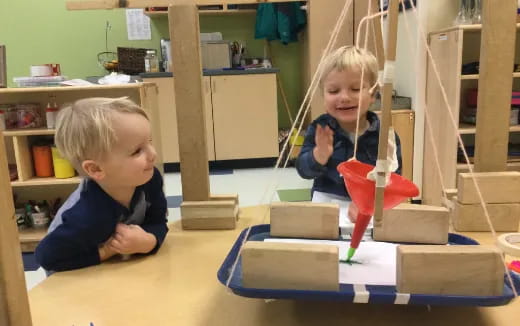 a couple of children playing with building blocks