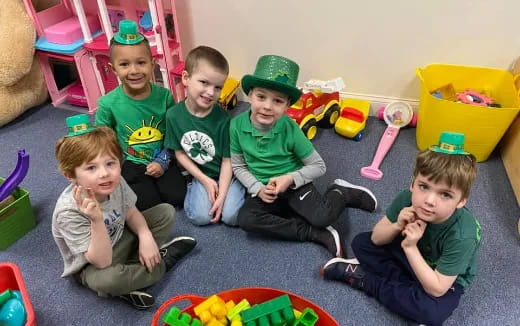 a group of kids sitting on the floor with toys
