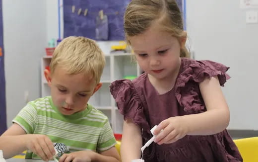 a couple of children sitting in a room