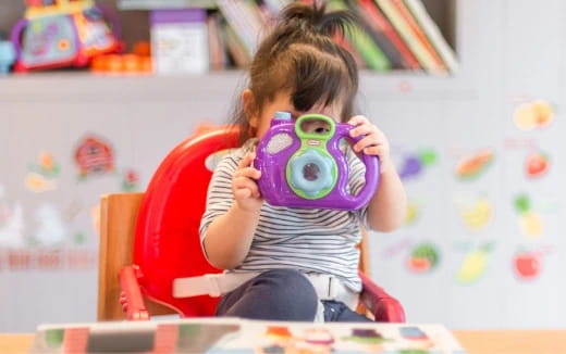 a girl holding a toy