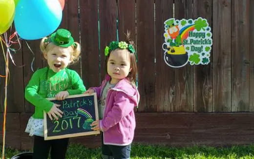 a couple of children holding a sign