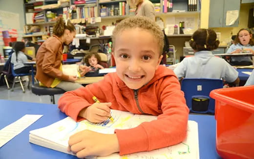 a boy sitting at a desk