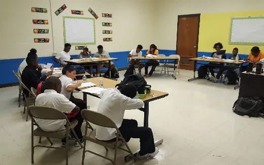 a classroom with students and a projector screen
