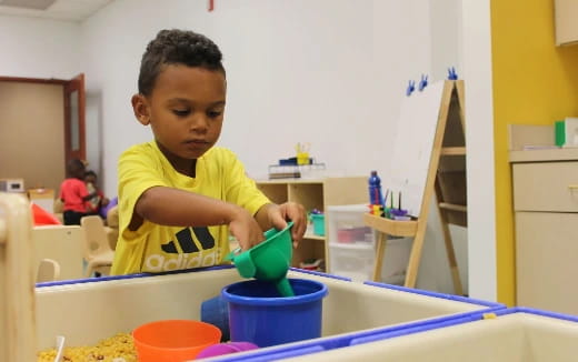 a young boy playing with a toy