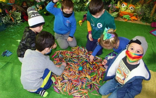 a group of children playing with a puzzle