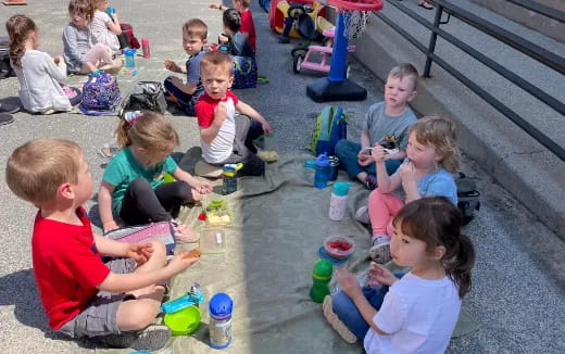 a group of children sitting on the ground