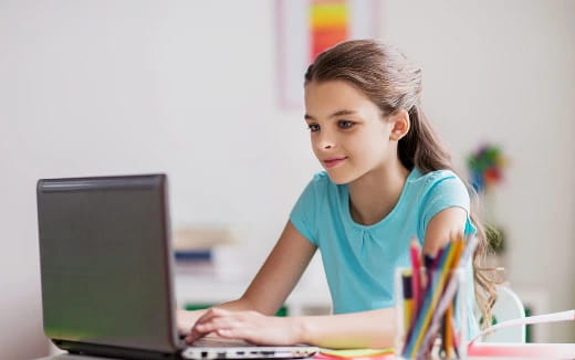 a young girl using a laptop