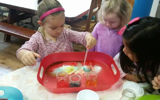 a group of children painting