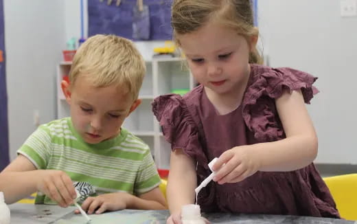 a couple of boys sitting at a table