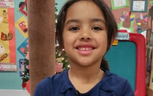 a girl smiling with her arm up