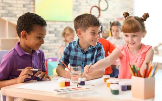 a group of children sitting at a table