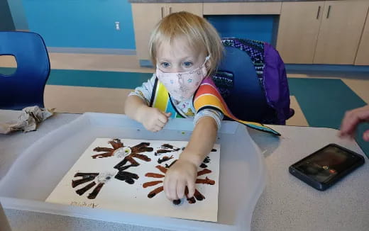 a child painting on a table