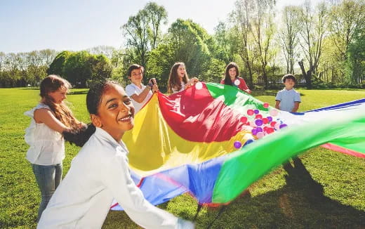 a group of people holding a kite