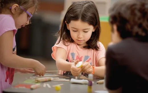 a young girl writing on a paper