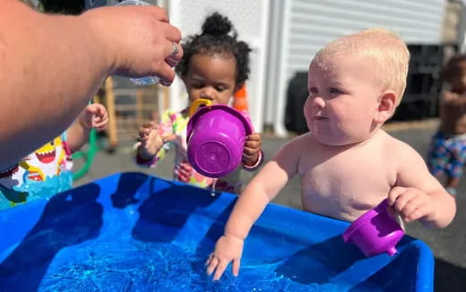 a baby playing with a ball