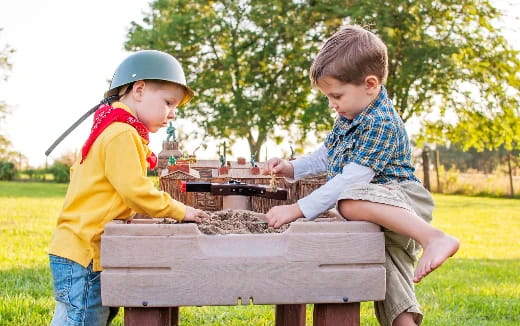 two boys playing with a toy