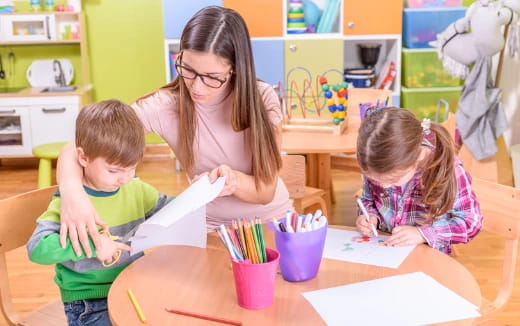 a person and two children sitting at a table